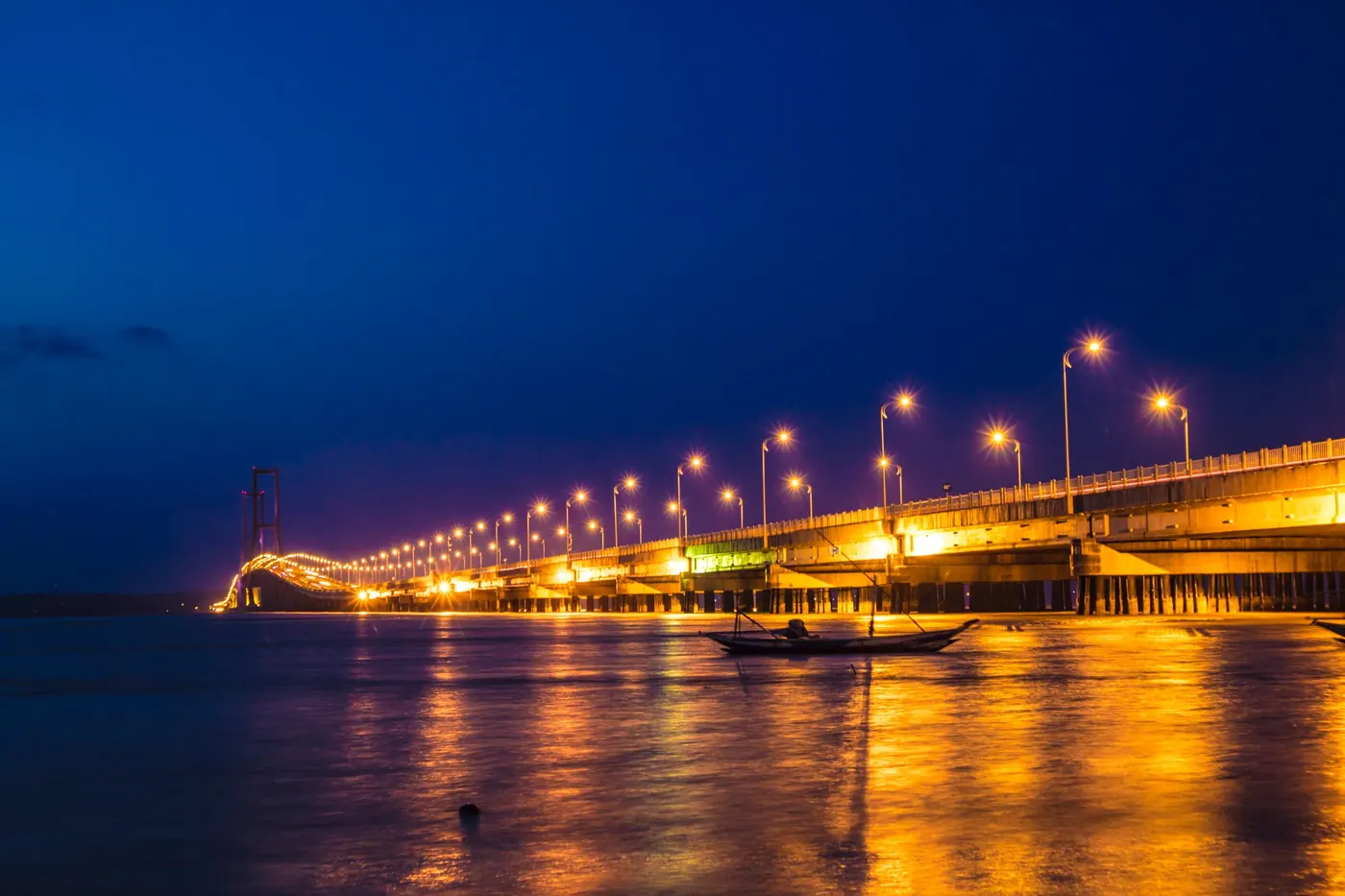 Bridge lit at night over the river